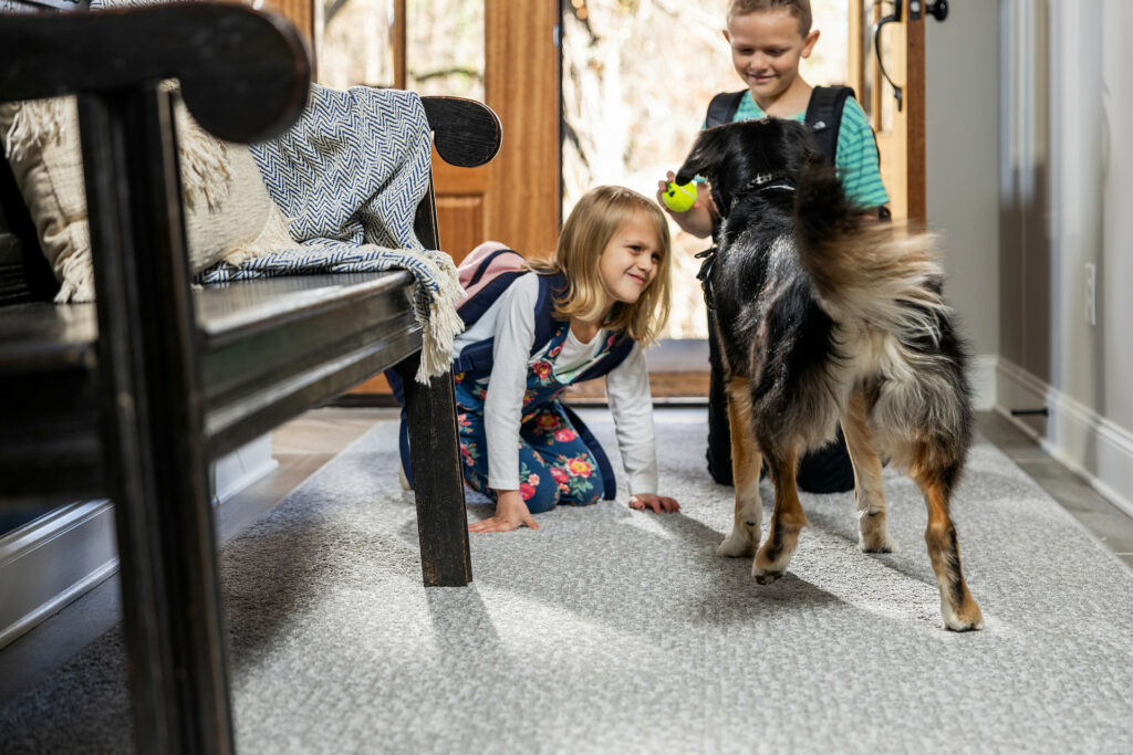 Kids on carpet floor with pet friendly | Custom Carpet Centers