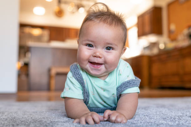 Baby lying on rug | Custom Carpet Centers